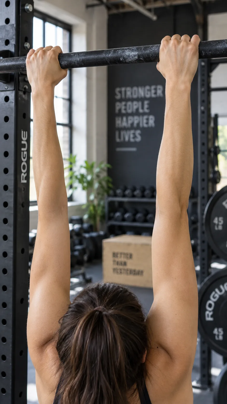Pull Up Progression: From Dead Hang to Your First Rep (Even If You Can't Do One Yet) 2 Close up of hands gripping a pull up bar in a dead hang position, showing proper grip and straight arms, gym setting, natural light