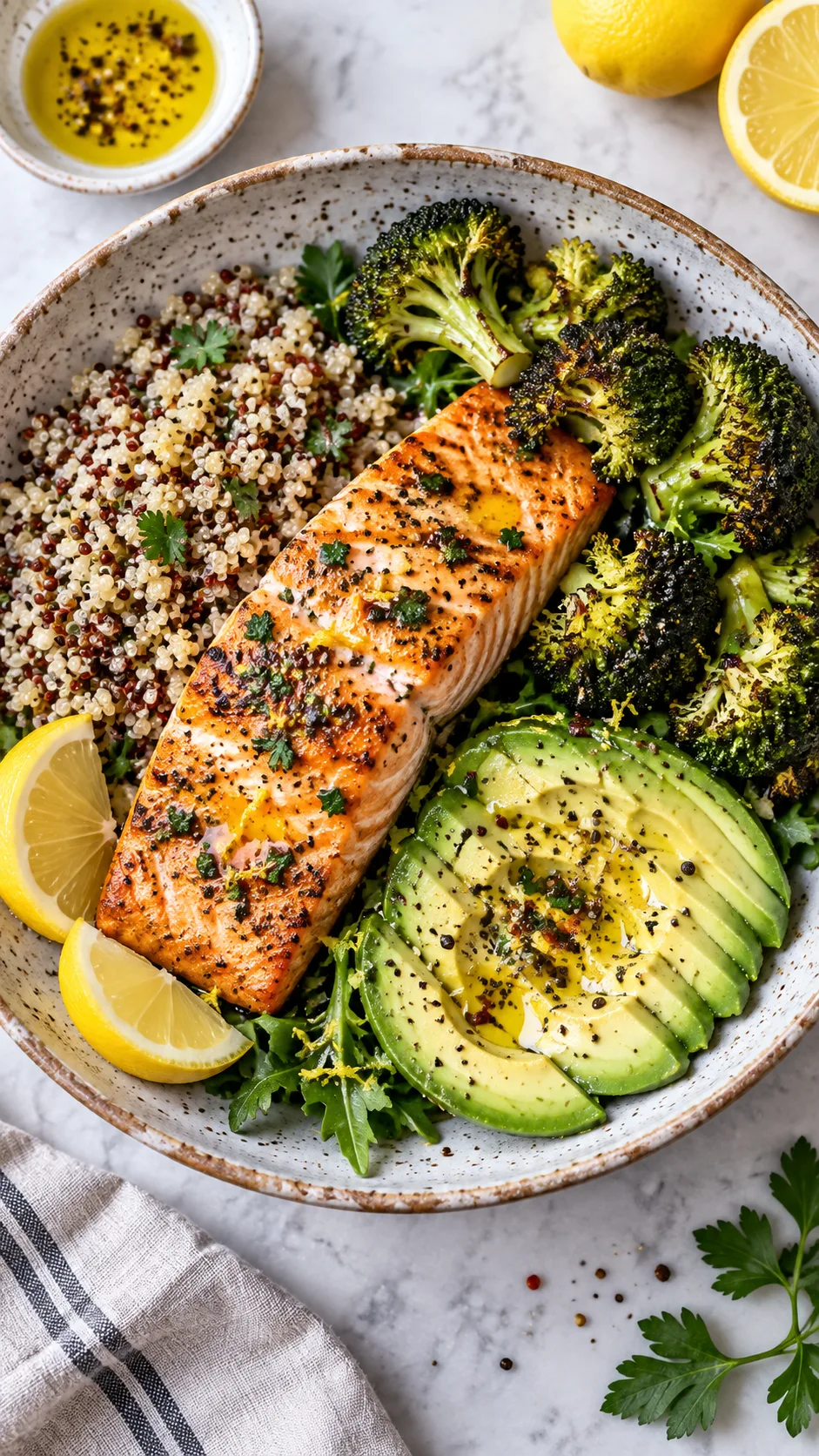 The Anti Inflammation Diet Meal Plan Beginners Actually Stick To 2 Close-up of a colorful anti-inflammatory bowl with grilled salmon, quinoa, roasted broccoli, avocado slices, and a drizzle of olive oil and lemon, shot from above on a ceramic plate, bright natural lighting